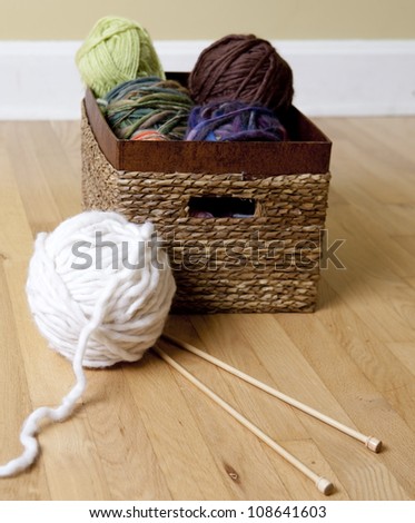 Basket full of yarn, chunky wool and knitting needles