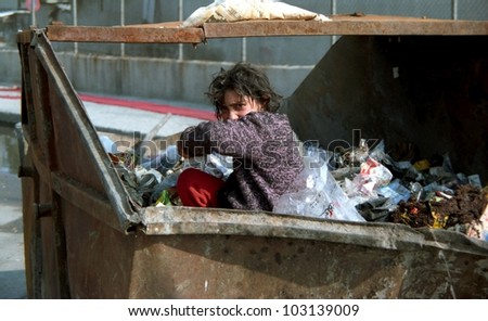Istanbul - Turkey - CIRCA 1989: An unidentified girl looks for something to eat in a dumpster circa 1989 in Istanbul, Turkey,