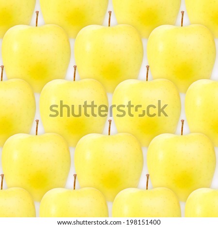 Abstract background of fresh yellow apples. Seamless pattern for your design. Close-up. Studio photography.
