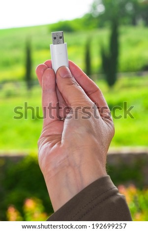 Close up of a pen drive in a hand as a concept of technology