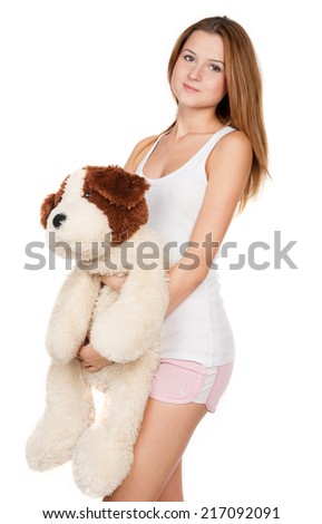 Beautiful girl holding a teddy dog on white background