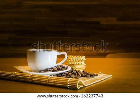 Coffee beans,coffee cup and crackers , Focus on coffee beans