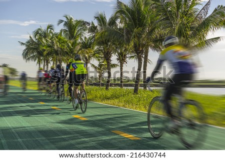 Group of cyclists on the green bicycle way