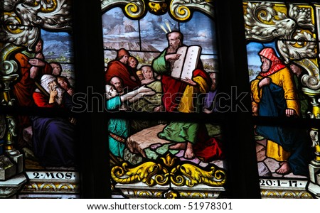 Stained glass window depicting Moses showing the Stone Tablets with the Ten Commandments. This window is located in Saint James\'s Church in Stockholm. It was fabricated in 1893.