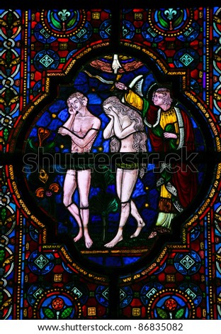 Expulsion of Adam and Eve from Paradise, stained glass window in the church of Dinant, Belgium.