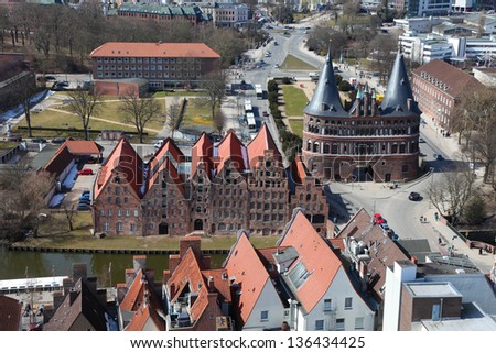Aerial view on the Holsten Gate (Holstein Tor, later Holstentor), a city gate marking off the western boundary of the old center of the Hanseatic city of Lubeck, Schleswig-Holstein, Germany.