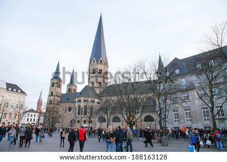 BONN, GERMANY - FEBRUARY 16, 2014:  Unidentified people in front of the Bonn Minster, one of the oldest churches of Germany. It is located in Bonn, North Rhine Westphalia, Germany.