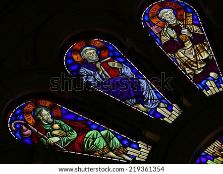 VIANA DO CASTELO, PORTUGAL - AUGUST 4, 2014: Stained glass window depicting Saint Peter, Saint Matthew and Saint James in the church of Viana do Castelo, Portugal.