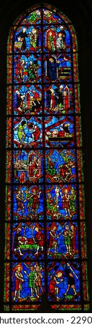 TOURS, FRANCE - AUGUST 14, 2014: Stained glass window depicting scenes in the life of a catholic saint, located in the Cathedral of Tours, France.