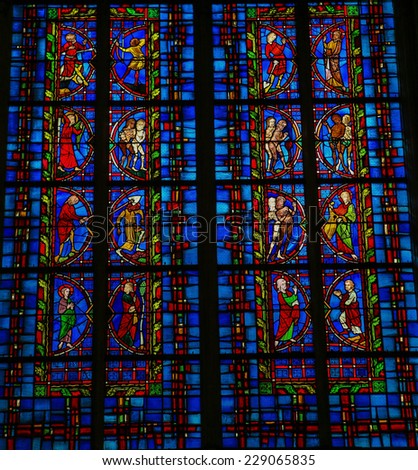 TOURS, FRANCE - AUGUST 14, 2014: Stained glass window depicting bible scenes with Adam and Eve in the Garden of Eden, located in the Saint Gatien Cathedral of Tours, France.