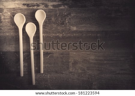 Wood spoons on wood background with a filtered look