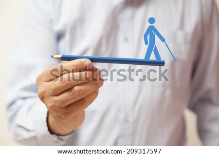 Man hand holding a pencil with a human figure on it