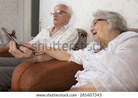 Happy senior couple using a tablet. Technology used by elders