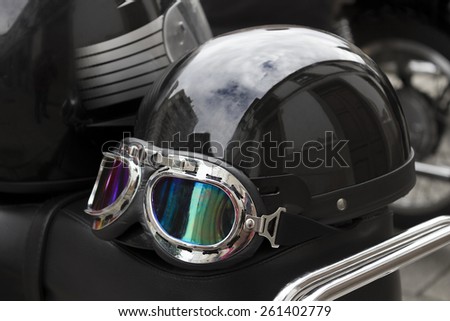 Black helmet with goggles of a motorist on the saddle of a motorbike. Stock photography.