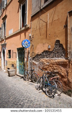 typical italian street with bikes under the wall
