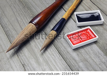 asian writing brushes and ink for calligraphy on wooden background
