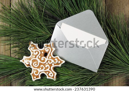 silver envelope with gingerbread on christmas fir tree