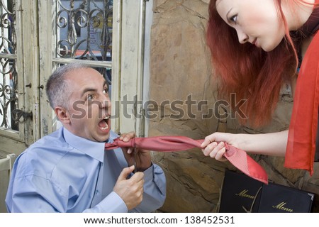 Man cuts his tie and tries to get off from a woman - Restaurant scene - Selective focus