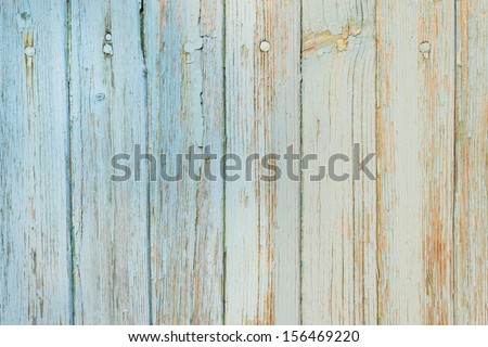 Abstract background - Old wooden planks with cracked light blue paint in daylight