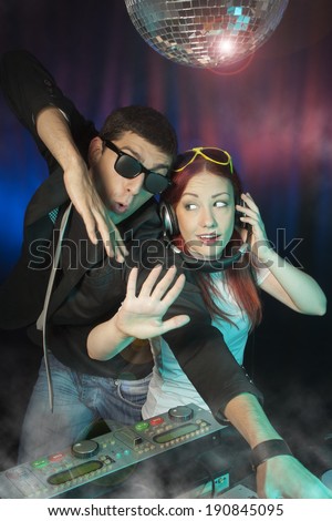 Young couple dancing in the night club. DJ dancing.