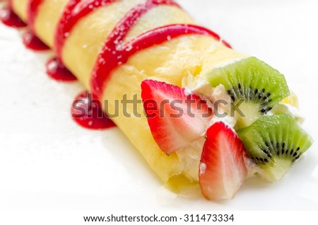 Roll crepes with berries and kiwi. Crepes, strawberry, raspberry, blueberry pancake topping.