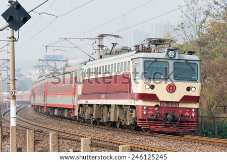 HENAN, CHINA - NOV 19 2014: China Railways SS7C electric locomotive in Luoyang, Henan, China. The locomotive is hauling passenger car.