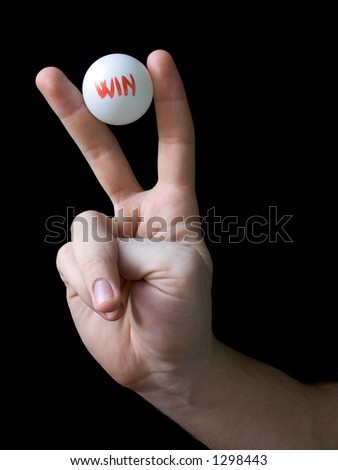 Hand holding winning lottery ball. Isolated on black.  Blank and unnumbered winner lottery ball