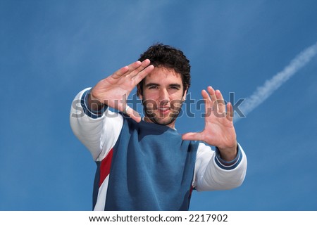 Happy young positive man. Happy student pointing hands. Strong and positive person concept