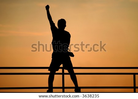Silhouette of jumping man. victory concept. Happy man with raised hand