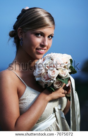 Beautiful the bride portrait with bouquet flowers. Soft dreamy look, sharp eyes and face