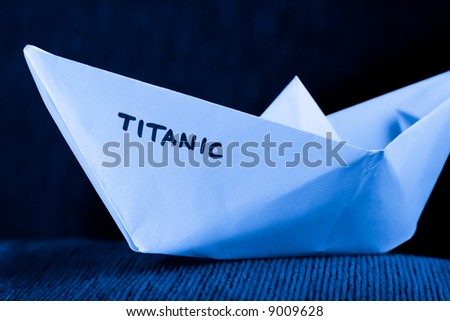 origami paper ship model in blue - titanic concept