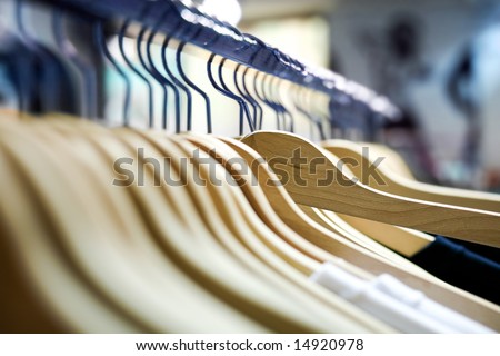 Clothes hangers with shirts in a store ready to sell. Fashion shopping store concept