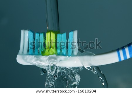Toothbrush with toothbrush and splashing water isolated on green in high detail concept