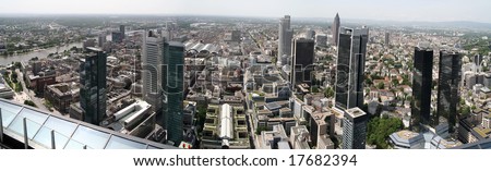 High resolution wide panorama of central Frankfurt at day sunlight with a river on left