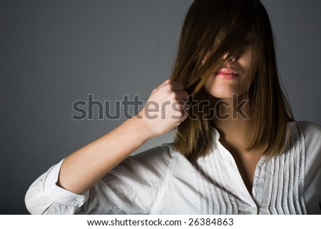 Woman pulling her hair. Healthy hair and hairstyle concept