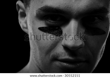 Handsome confident man with black line on face