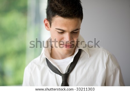 Handsome young man head and shoulders portrait with simple background copy space