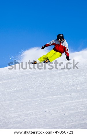 Aggressive skier in the snow powder turning left
