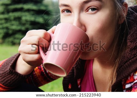 a Beautiful girl drinking tea, or Tea cup, Beautiful face, a Cup in hands