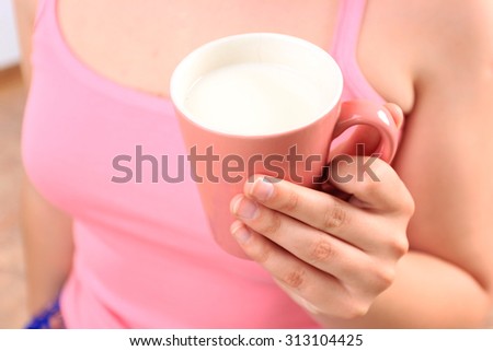 a Beautiful girl with cup of milk, a Cup of milk, Drinking milk, Healthy breakfast, Calcium, Vegan food, Healthy food, Soya milk, Healthy lifestyle