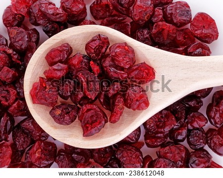 Dried cranberries (Vaccinium macrocarpon)  in wooden spoon