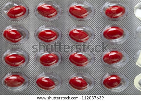 Close up of a pill blister with red pills