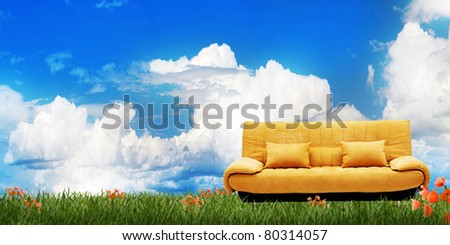 yellow sofa, spring meadow, cloudy summer sky