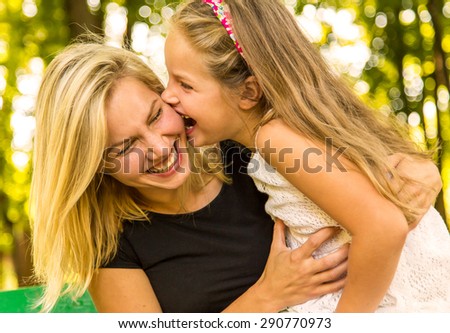 Happy Mom and Daughter Having Fun Outdoors, happy family