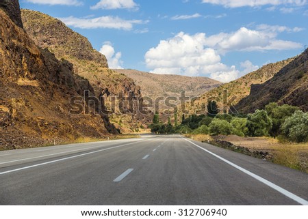 view of an empty beautiful road surrounded by the nature