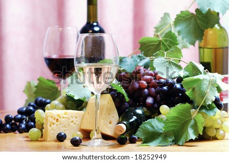 Bottle, cheese and glasses of wine