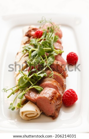 grilled duck breast covered with sweet red fruit sauce