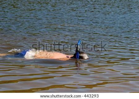a young boy swimming and cooling off on a hot summer day