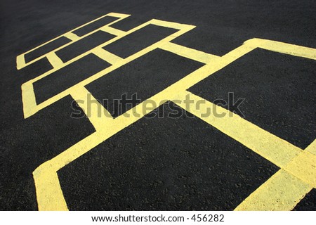 hopscotch jumping game at a school, yellow on black