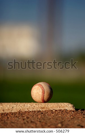 baseball close up on pitcher\'s mound, late afternoon sun